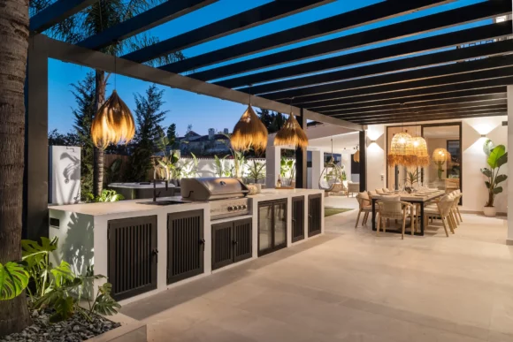 Zona de barbacoa confortable y elegante en una residencia de lujo en la Milla de Oro de Marbella al atardecer